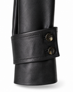 Buttoned cuff-tab detail on black sheepskin jacket