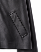 Angled welt pocket detail on black sheepskin jacket