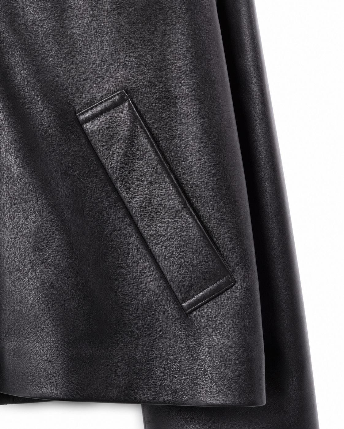 Angled welt pocket detail on black sheepskin jacket