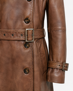 Leather waist belt and buckled cuff detail on brown trench coat