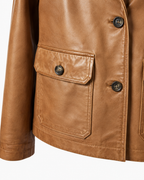 Buttoned flap pocket detail on tan sheepskin leather blazer